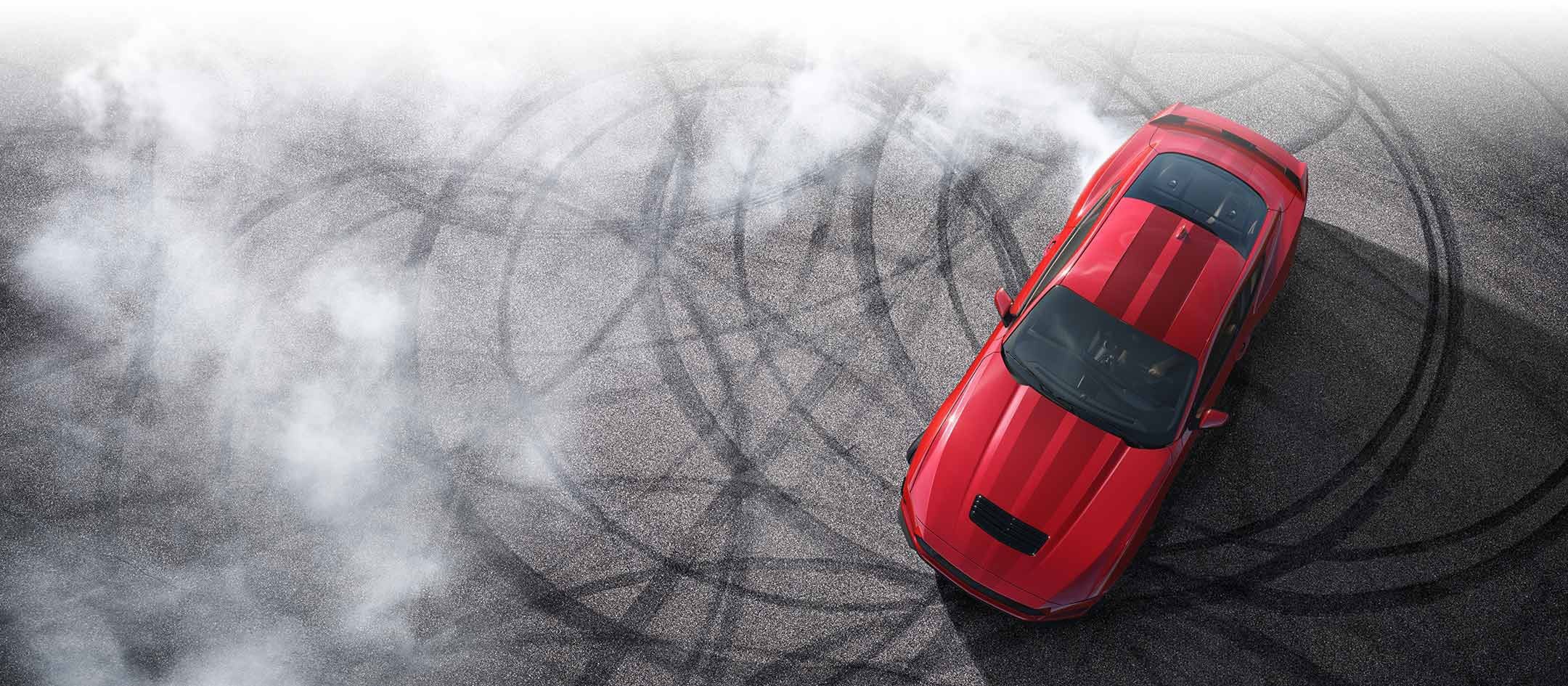 Overhead view of a 2024 Ford Mustang® model with tire tracks on pavement | Burlington Ford in Burlington CO