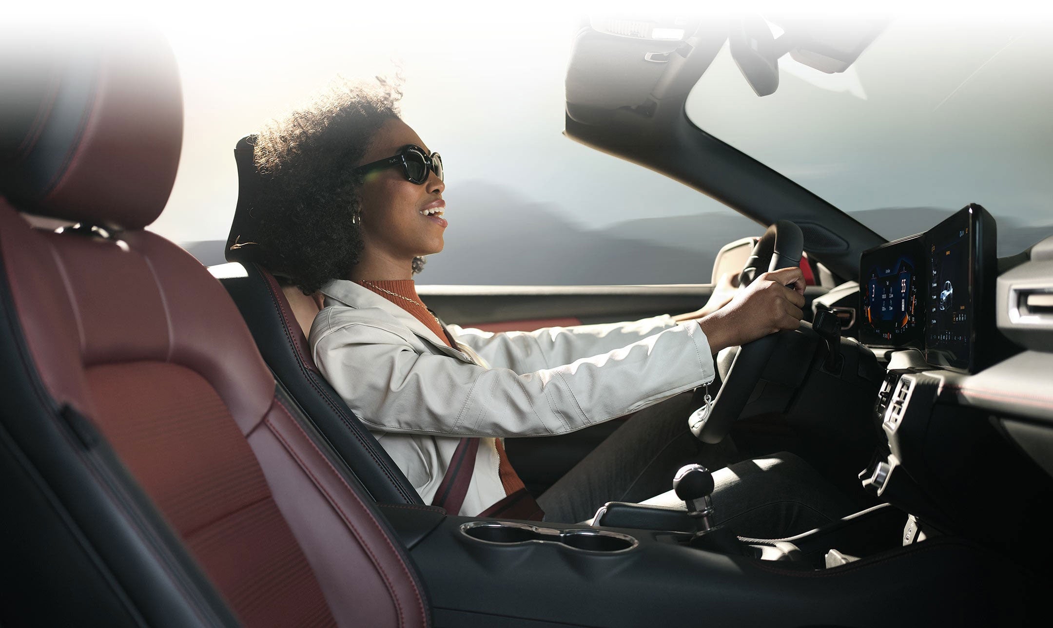 Person sitting in the driver’s seat of a 2024 Ford Mustang® convertible | Burlington Ford in Burlington CO