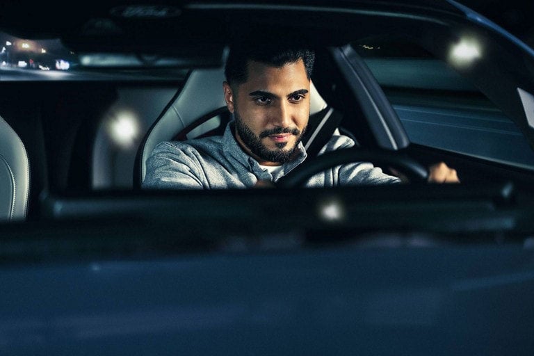 Person sitting in the driver’s seat of a parked 2024 Ford Mustang® coupe | Burlington Ford in Burlington CO